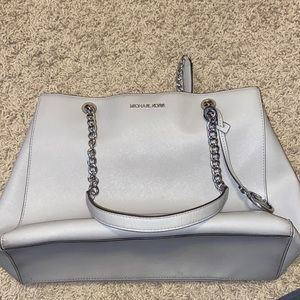 A grey Michael Kors chain purse. All grey and silver leather